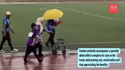 Teacher patiently accompanies a specially abled child to complete his race on the tracks amid pouring rain; social media can’t stop appreciating the humility | Teacher patiently accompanies a specially abled child to complete his race on the tracks amid pouring rain; social media can’t stop appreciating the humility |